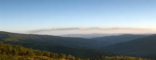 Scenic panoramic view of Mukteshwar with Himalayan peaks and lush green valley